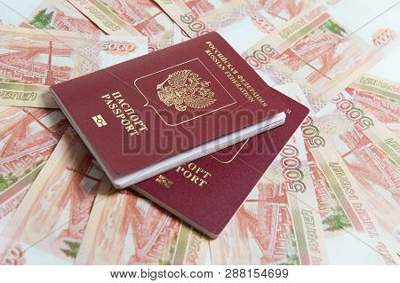 Biometric Passport And Two Banknotes For A Hundred Dollars Visa Free Travel. Travel Expenses Concept