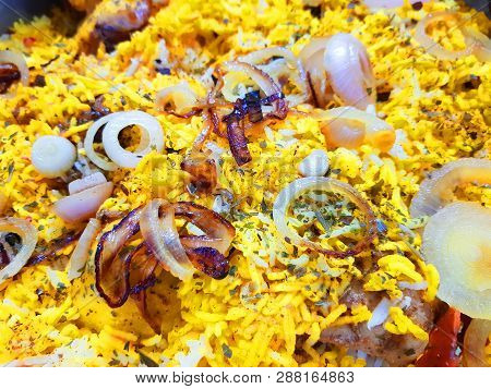 Close Up Photo Of Hyderabadi Dum Handi Biryani Garnished With Onions