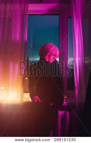 Fashion Woman Pink Hair Near The Window. Pink Light. Life Style. Retro Wave Neon Noir Lights Color T