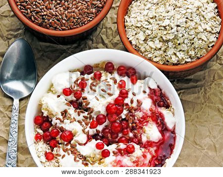 Delicious And Healthy Breakfast With Oat Flakes, Yoghurt, Flaxseed And Cowberry. Energy Breakfast Co