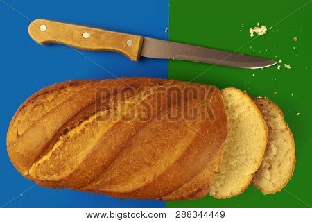 Breadsliced Loaf Of Bread And A Knife On Blue-green Background