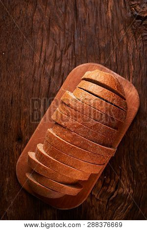 Top View Of Sliced Wholegrain Bread On Dark Ructic Wooden Background Closeup