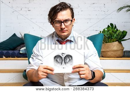 Serious Professional  Psychologist Showing Paper With Rorschach Inkblot