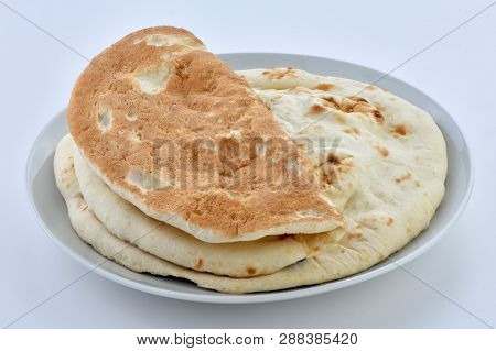 Tandoori Naan. A traditional Pakistani flat bread baked in clay oven.