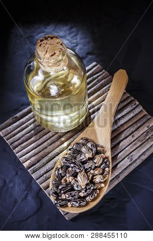 Beans And Castor Oil On The Black Table