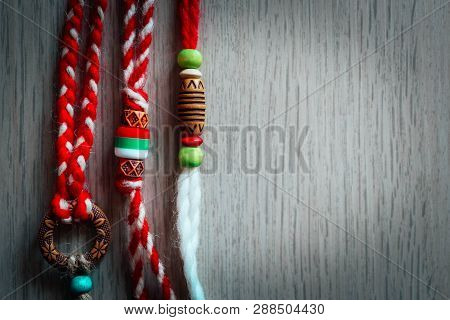 Bulgarian Traditional Spring Decor Martenitsa Bracelets, Wooden Background. Baba Marta Holiday, Back