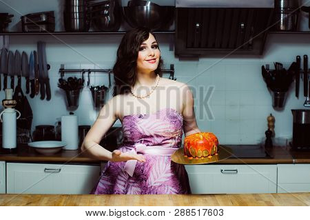 Smiling Hostess Holds Cake Like Big Donut With Fondant