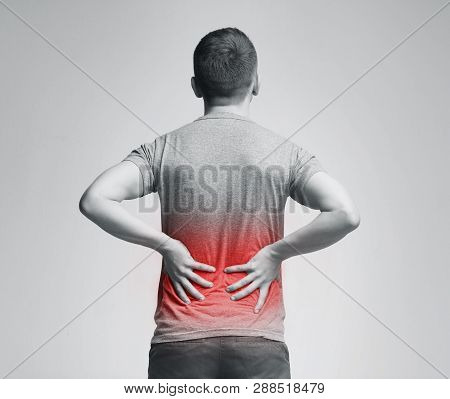 Man Holding His Hands Behind His Back, Pain In Spine, Inflamed Zone Highlighted In Red