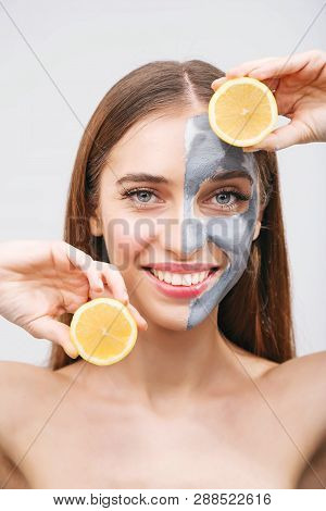 Lovely, Smiling Girl Having Fun With Two Halves Of Lemon, Indoor Shot In The White Background