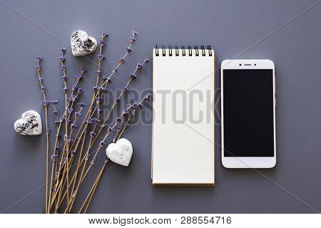 Blank Noteboook, Smartphone And Dry Lavender Flowers