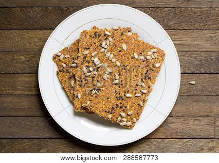 Dehydrated Vegan Raw Bread Loaves On White Dish On Wooden Table With Copy Space. Raw Food Diet. Top 