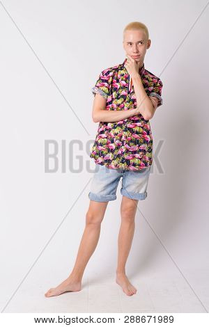 Full Body Shot Of Young Happy Androgynous Tourist Man Thinking