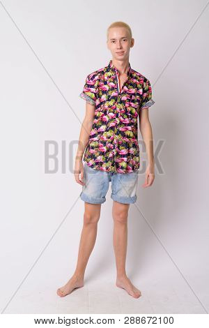 Full Body Shot Of Young Happy Androgynous Tourist Man Smiling