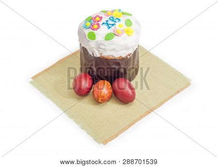 Sweet Easter Bread Covered With Sugar Icing And Decor In Parchment Baking Paper And Easter Eggs Dyed