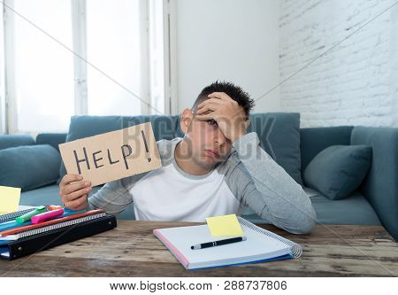 Young Desperate Student In Stress Working And Studying Holding A Help Sign.
