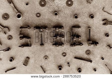 Letter Word Is Steel By Old And Rusty Nut On Dirty Ground