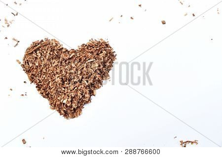 Heart-shaped Wood Saw Dust On Dirty White Background