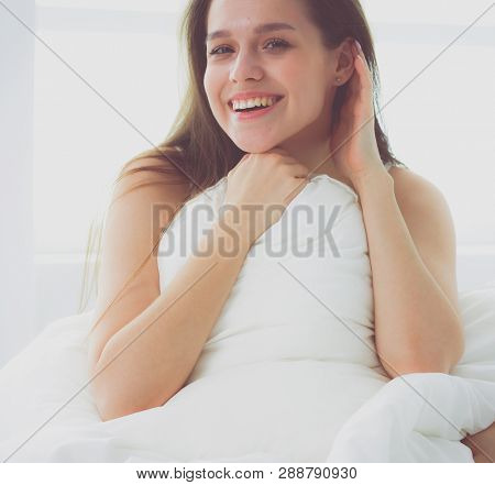Young caucasian woman covering her head and ears with pillows