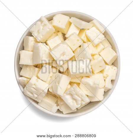 Sliced Feta Cheese In Bowl Isolated On White Background. Top View.