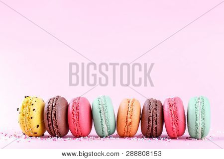 Colorful French Macarons On Pink Background Traditioanal Desert In France