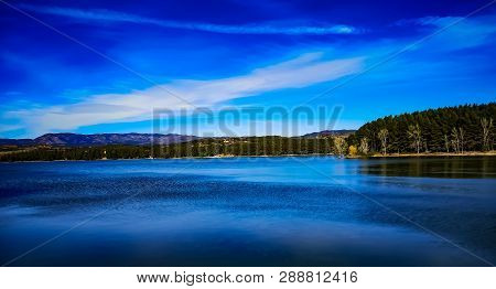 View Of The Regajo Reservoir With The Mountains In The Background