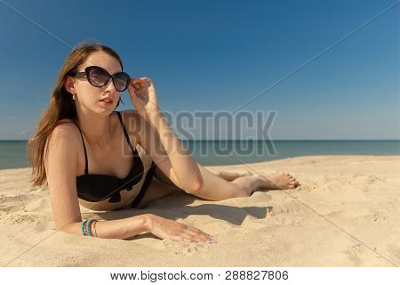 Beautiful Young Woman In Swimsuit At Sand Sea Beach Looking At Camera