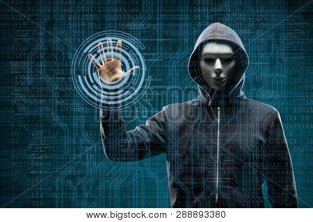 Computer Hacker In Mask And Hoodie Over Abstract Binary Background. Obscured Dark Face. Data Thief, 