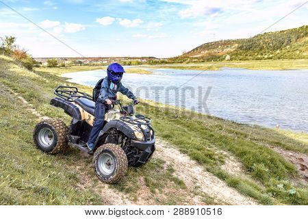 The Boy Is Traveling On An Atv. Beautiful View.