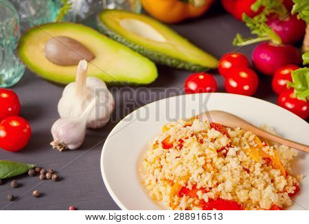 Homemade Vegetarian Couscous With Tomatoes, Carrots, Pepper On A Dark Kitchen Table With Vegetables 