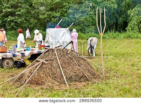 Rest After Haymaking. Mow The Grass By Hand. Summer, Haymaking, Haystack. Mowing Grass Is A Slanting