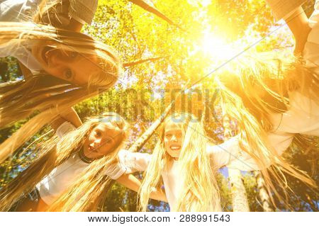 A Group Of Girls Hugging Themselves Formed A Circle, Bent Down, Looking Down. Walk In The Summer For