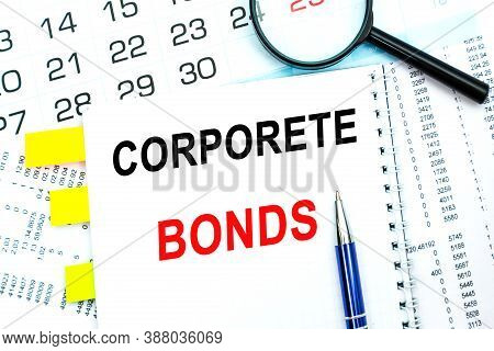 Text Corporete Bonds On Financial Tables With Magnifying Glass. Business And Financial Conzept. Calc
