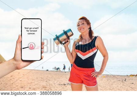 A Females Hand Holds A Smartphone With An Inscription About A Breast Cancer Test. In The Background 