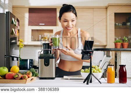 Smiling Foof Blogger Video Chatting With Her Subscribers And Showing Delicious Fresh Juice She Made 