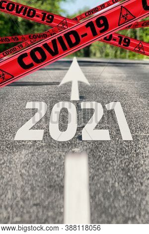Covid-19 In 2021 Is Ahead. Asphalt Road With Road Markings, Yellow Warnings Tapes Labeled Covid-19 A