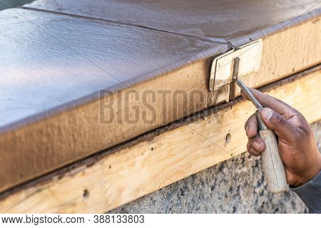 Construction Worker Using Hand Groover On Wet Cement Forming Coping Around New Pool.