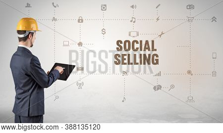 Engineer working on a new social media platform with SOCIAL SELLING inscription concept
