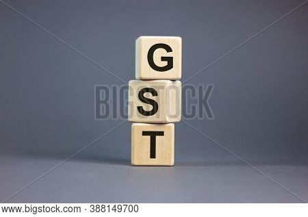 Concept Words 'gst, Goods And Services Tax' On Cubes On A Beautiful Grey Background. Business Concep