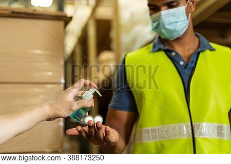 Cropped Engineer Worker Using Alcohol Based Hand Sanitizer Gel For Washing Hand While Working In Fac