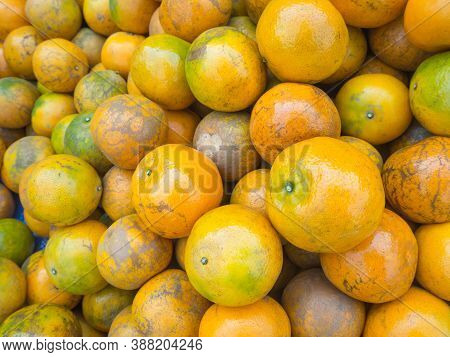 Pile Of Tangerines For Sale In The Market. Full Frame Photo. Concept Of Fruits Healthy