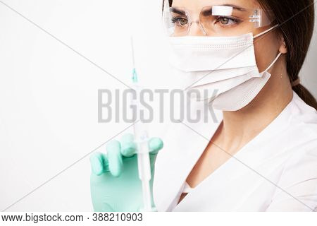 Woman Holding Medical Injection Syringe In Her Outstretched Hand Towards The Camera.
