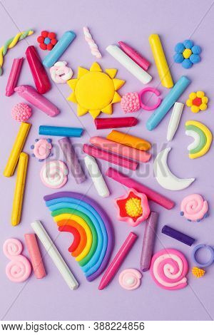 Abstract Purple Pastel Background With Many Kids Accessories From Clay, Wax Chalk, Concept Of Pop Ar