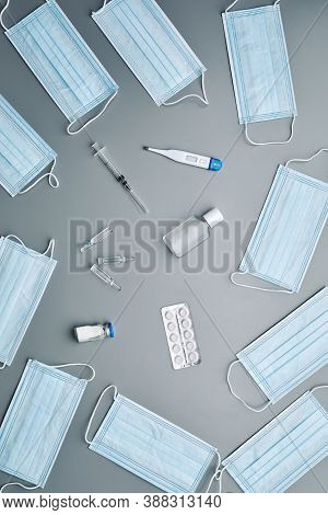 Top View Background Composition Of Medical Masks Framing Antibiotics And Thermometer In Center Over 