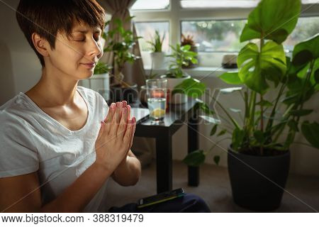 Close Up Woman Practicing Meditation And The Practice Of Gratitude Using Phone App. Cozy Space With 