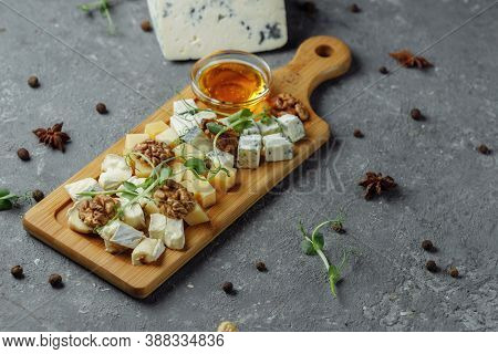 Close-up Of A Cheese Plate. 4 Types Of Cheese, Soft White Brie Cheese, Camembert, Semi-soft Briques,