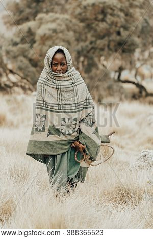 Simien Mountain, Ethiopia, April 25.2019, Little Ethiopian Shepherdess Girl Veiled In A Blanket With
