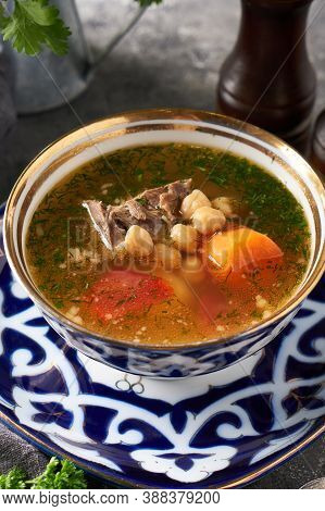 Traditional Asian Shurpa Soup In Traditional Ornament Bowl On Ray Background