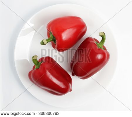 Red Pepper On The Plate. Isolated On White Background. Shot From Above.