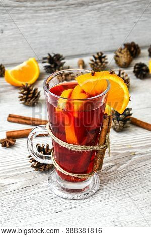 Christmas Mulled Wine With And Orange On Wooden Rustic Background. Selective Focus. Anise Stars And 
