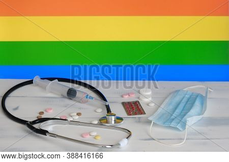 Lgbt Flag On The Background Of Pills , Stethoscop E An D Medical Mas K O N The Table. The Flag Of Se